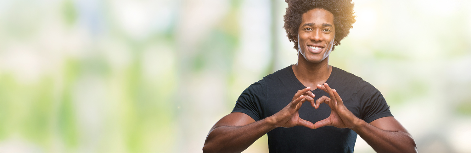 person with hands making heart shape