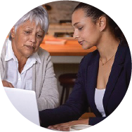 A personal health navigator and her client looking at a laptop